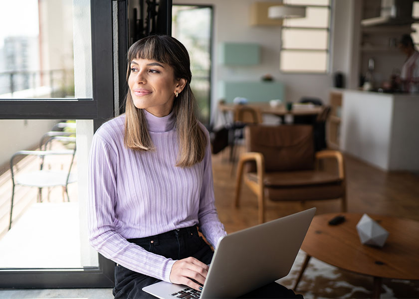 Woman pausing during work to look out the window