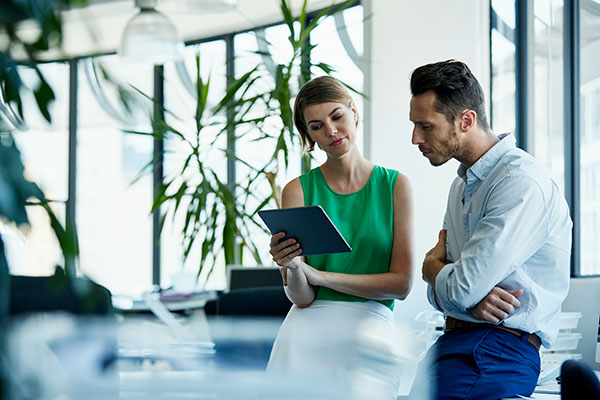 two people working together on a computer